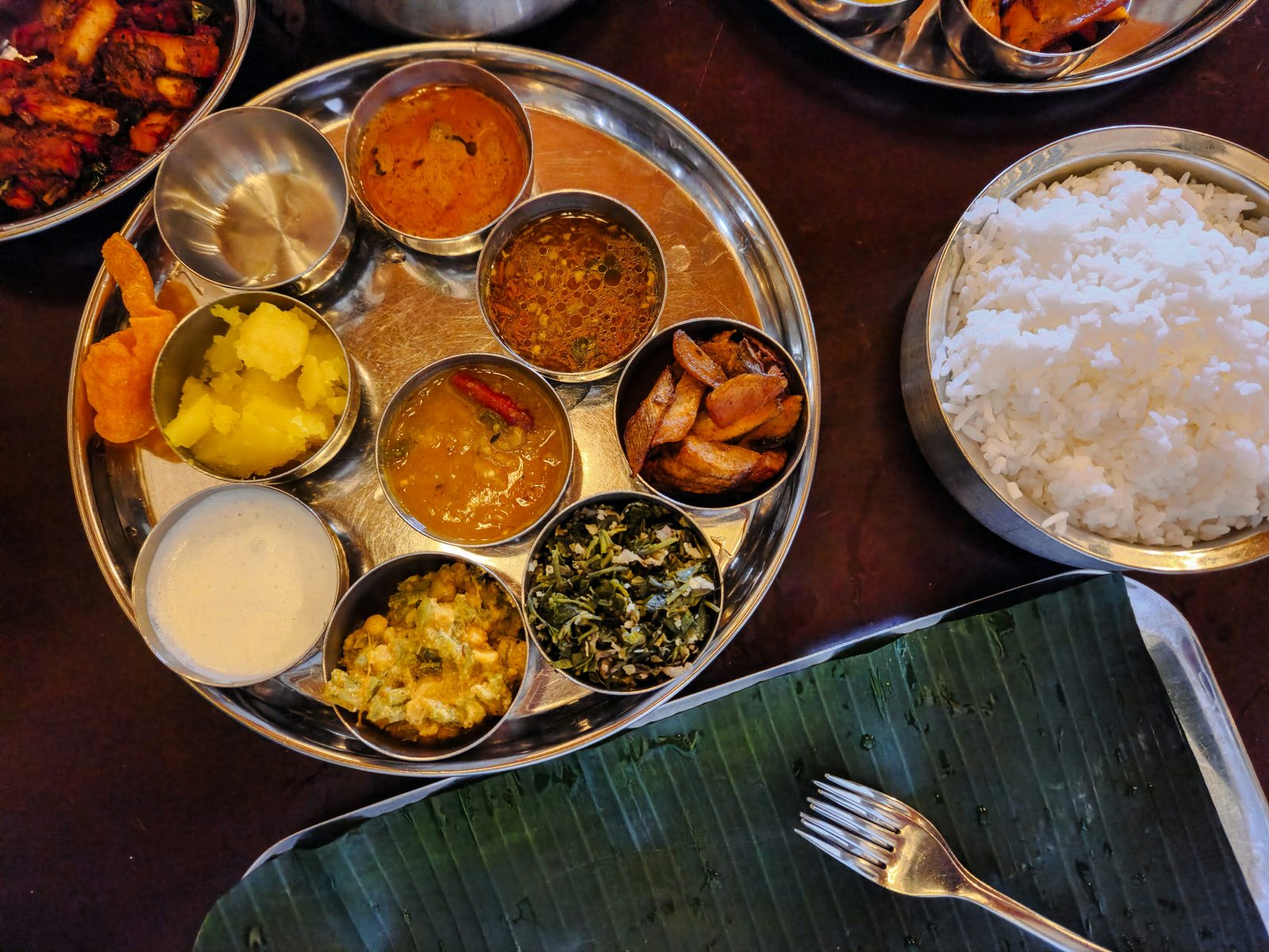 A colorful South Indian thali with rice and assorted curries